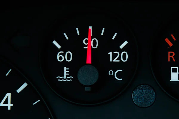 Car temperature gauge on dashboard showing safe temperature