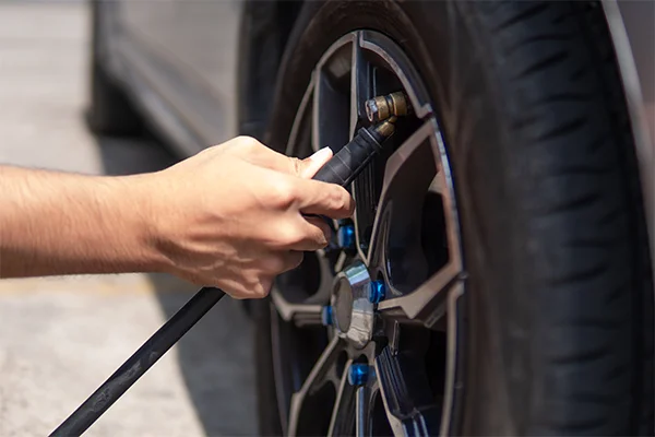 technician filling tire with air