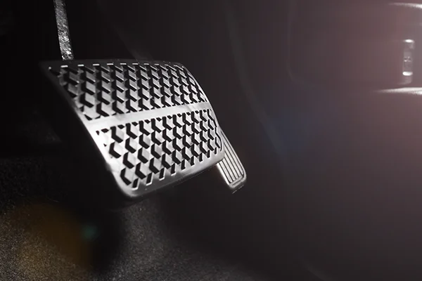 Brake and accelerator pedal in footwell of vehicle interior
